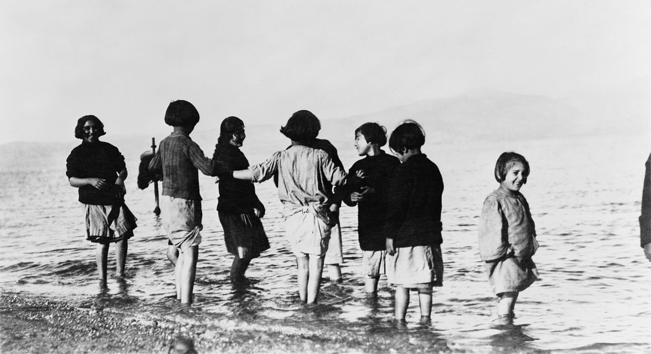 1280px-Greek_and_Armenian_refugee_children_in_the_sea_near_Marathon,_Greece,_c._1915